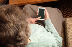 Elder woman with smartphone on her hand