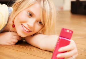 teenage girl making self portrait with smartphone